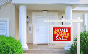 home for sale with sold sticker on sign
